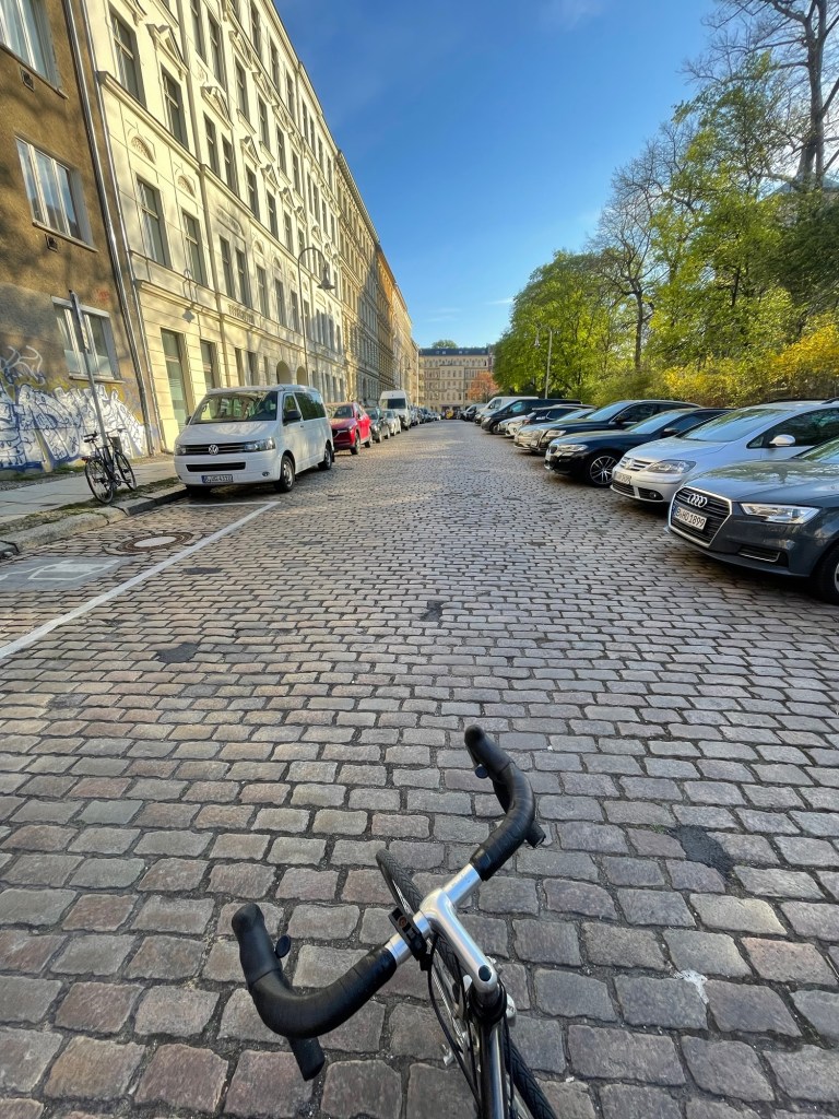 Cycling down a cobblestone street in Berlin on an early morning